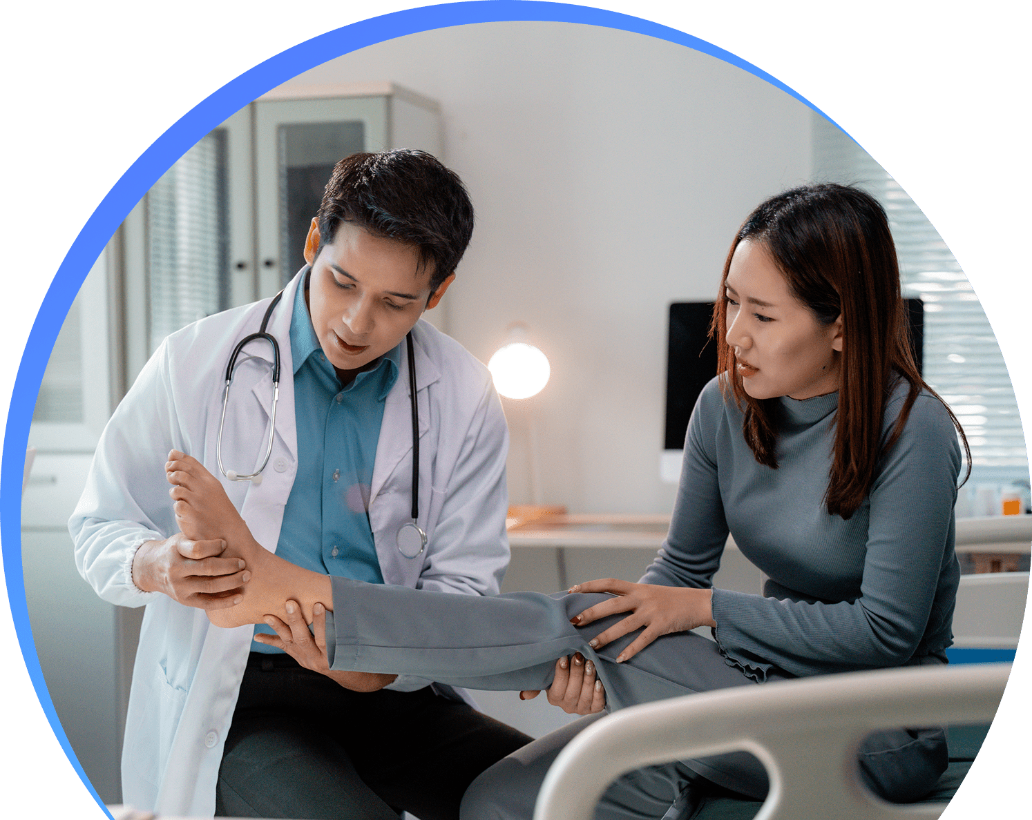Doctor examining patient's leg in clinic.