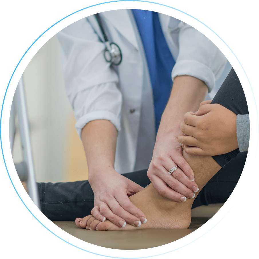 Doctor examining a patient's ankle with supportive hands.