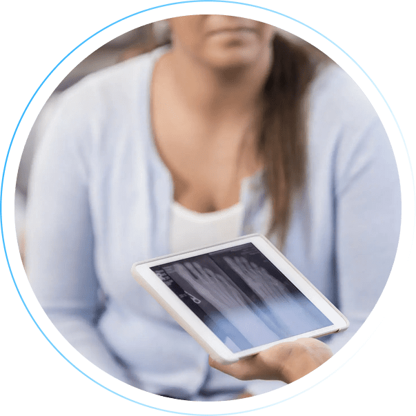Person holding a tablet with a blurred background.